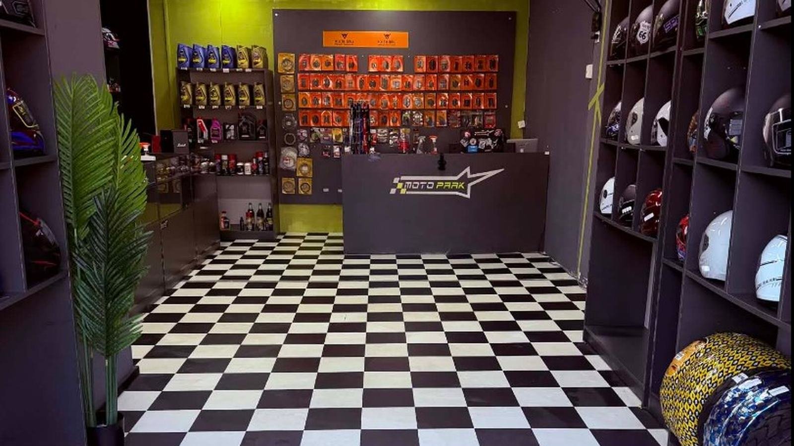 Moto Park shop floor in Tbilisi with helmets along the walls