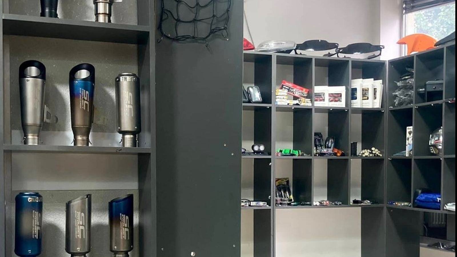 Showroom shelves with exhaust cans and accessories