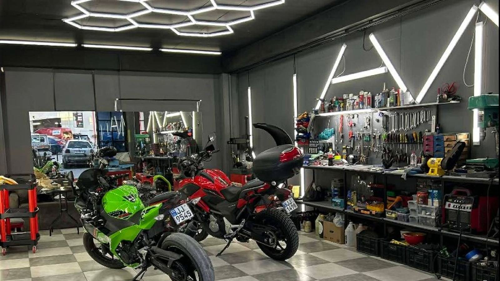 Moto Park workshop in Tbilisi, motorcycles under hexagon lighting