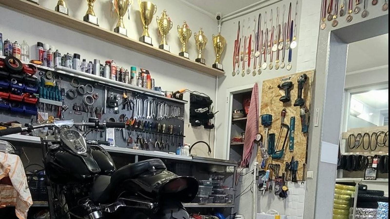 Racing trophies on a shelf in the Moto Park workshop