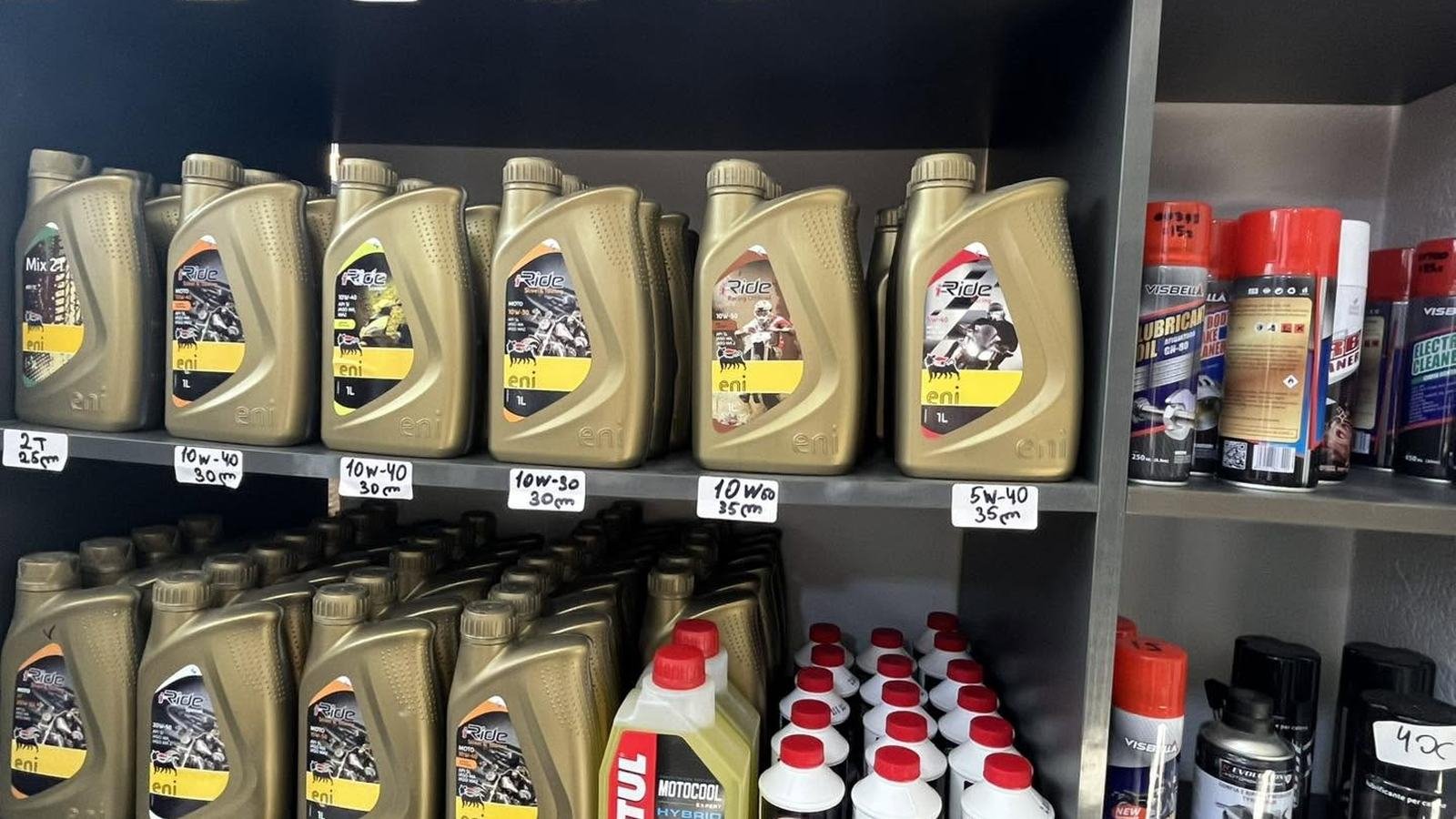 Shelf of eni motorcycle engine oils with price tags